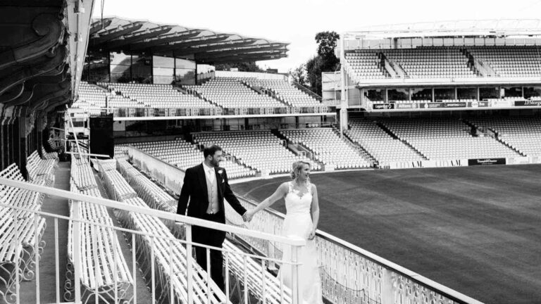 A couple on the Pavilion balcony above the stands, Lord’s Cricket Ground