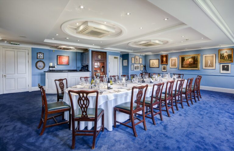 A long table laid beneath cricketing paintings, Lord’s Cricket Ground