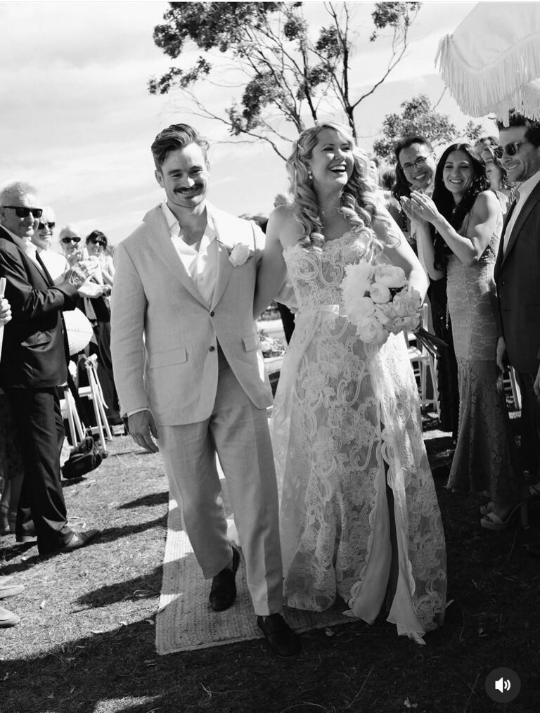 A couple walk together after their ceremony, coastal Sydney, Lorella Giannini