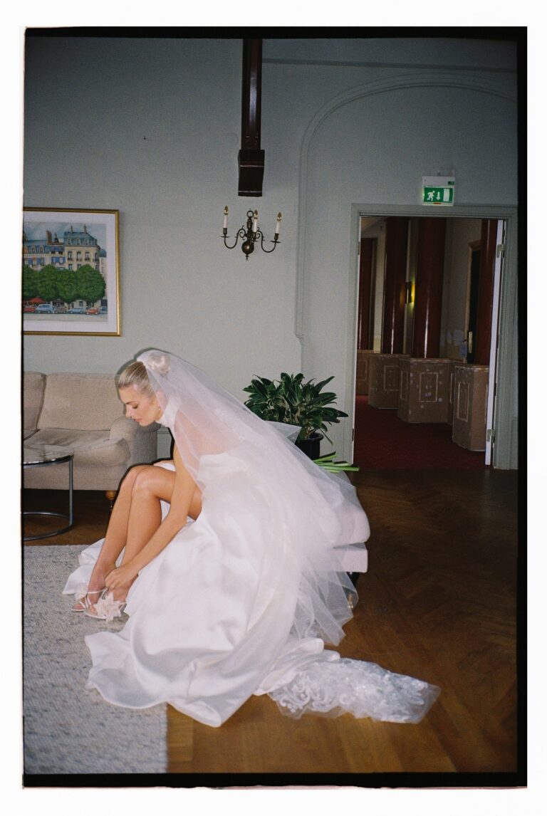 A bride seated alone, her veil pooling on the floor, Lorella Giannini
