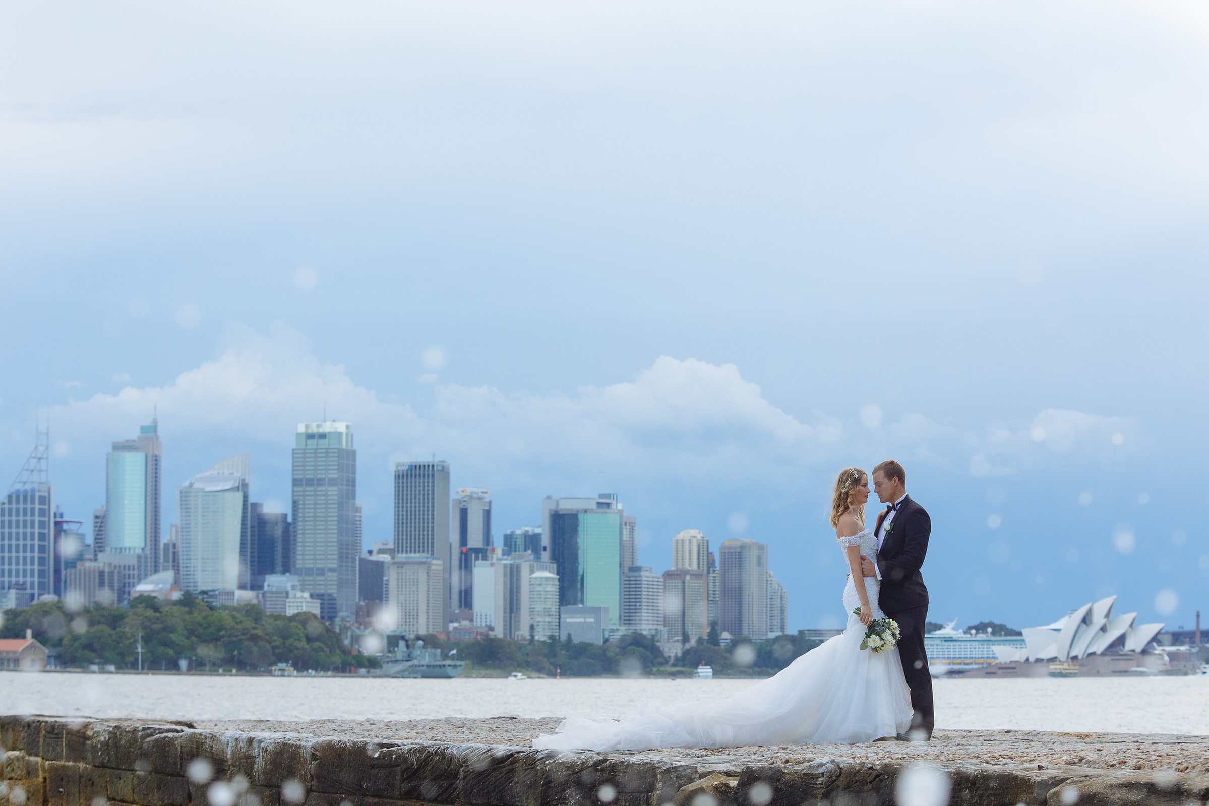 A couple on the Sydney foreshore, the Opera House and skyline behind, Lorella Giannini
