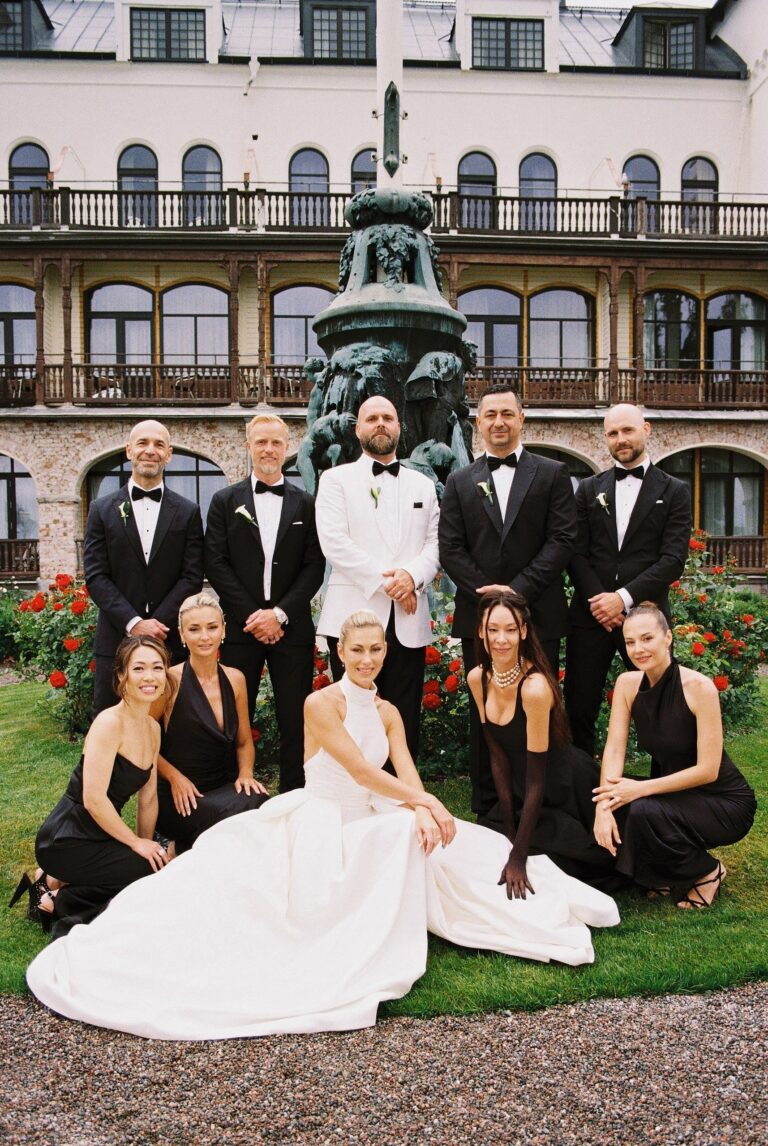 The full bridal party, gathered at a fountain courtyard in Sweden, Lorella Giannini