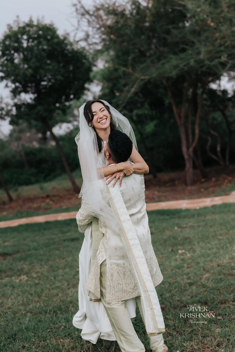 A joyful walk down the red carpet under a floral mandap. Photograph: Vivek Krishnan Photography, Lorella Giannini