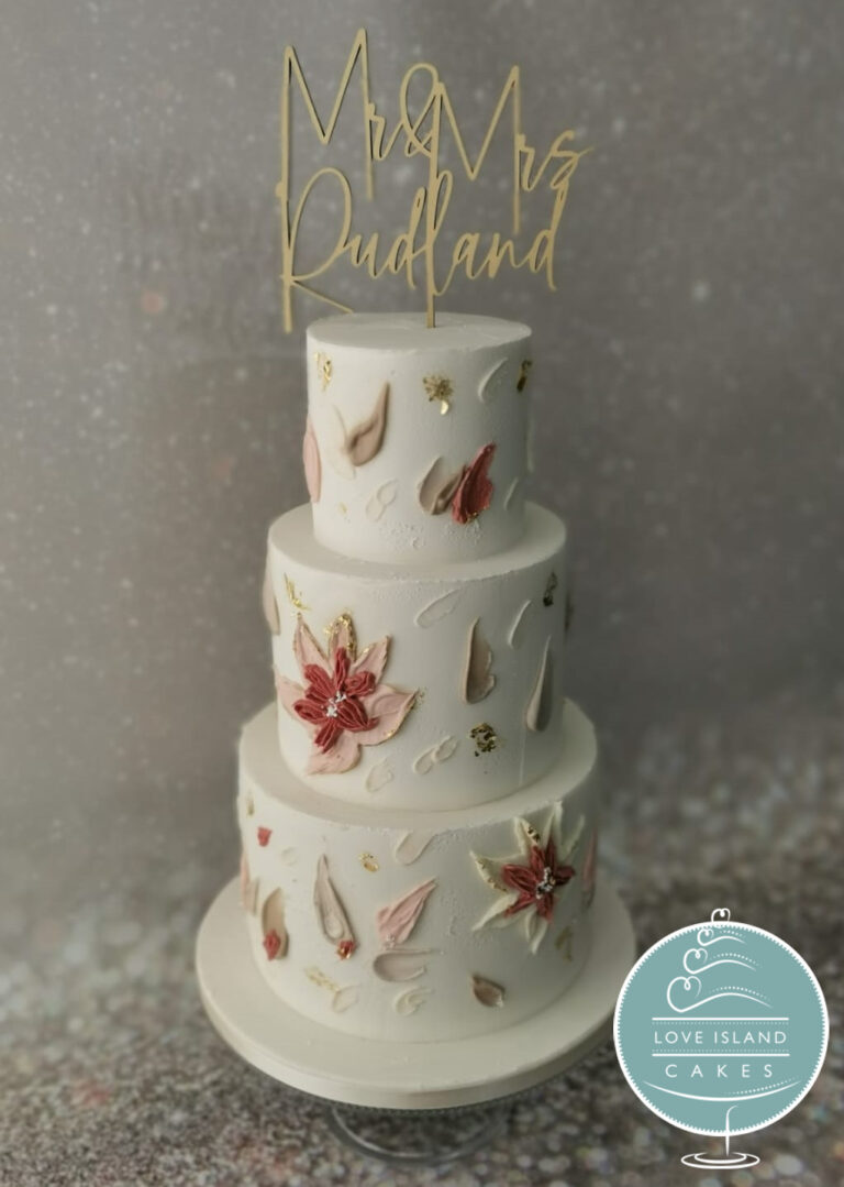 A three-tier cake hand-painted with autumn botanical motifs and a gold Mr and Mrs topper, Love Island Cakes