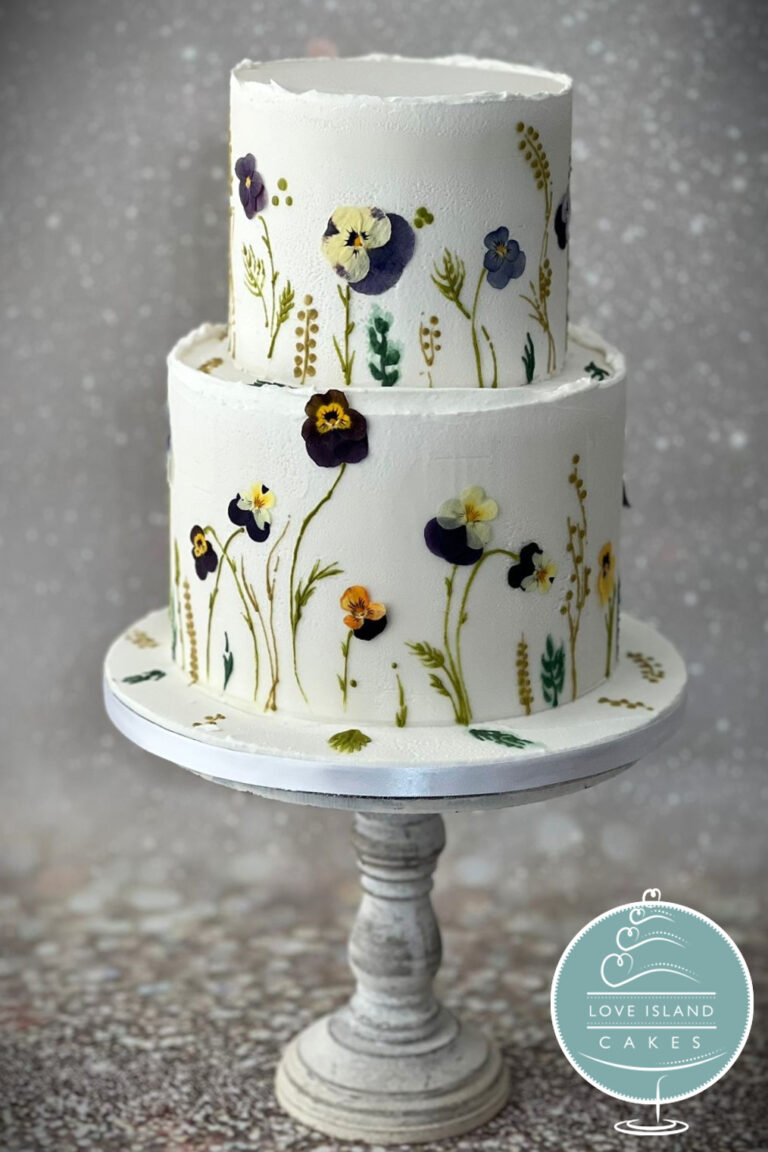A two-tier cake decorated with pressed flowers and grasses, Love Island Cakes