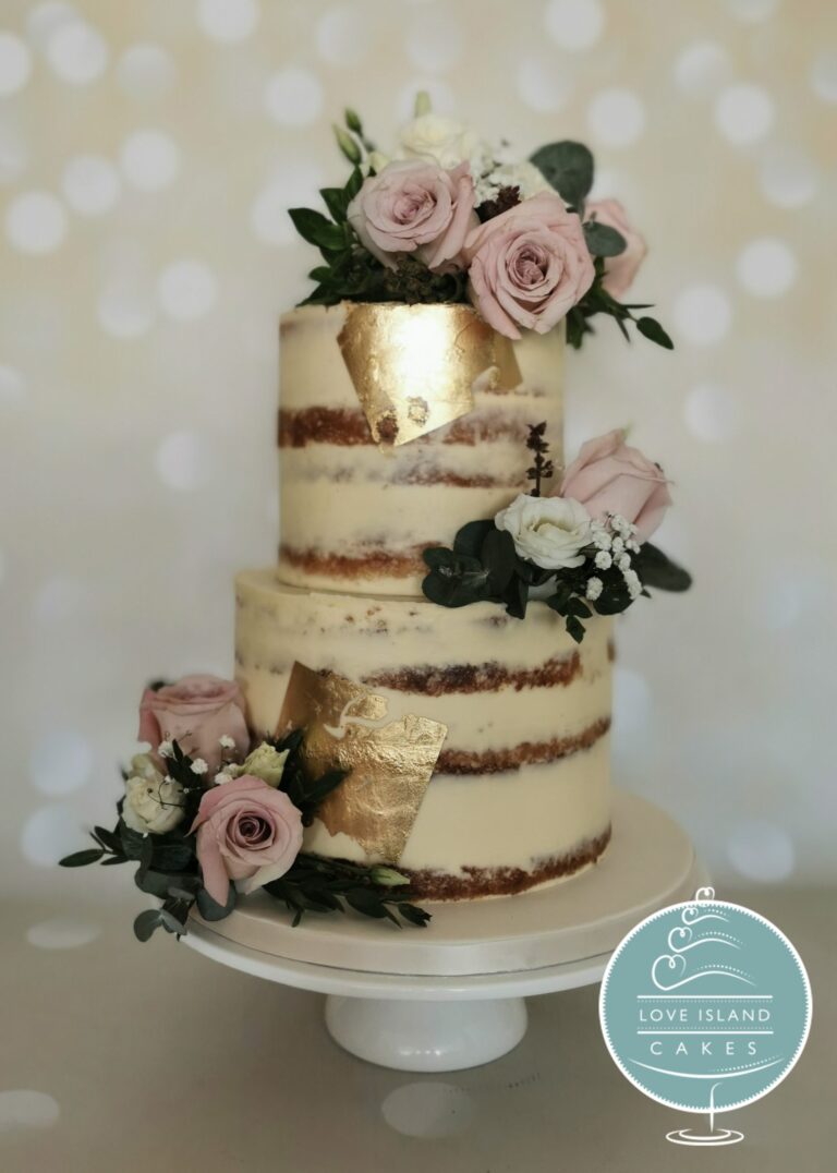 A semi-naked cake with gold leaf and dusky pink roses on a white stand, Love Island Cakes
