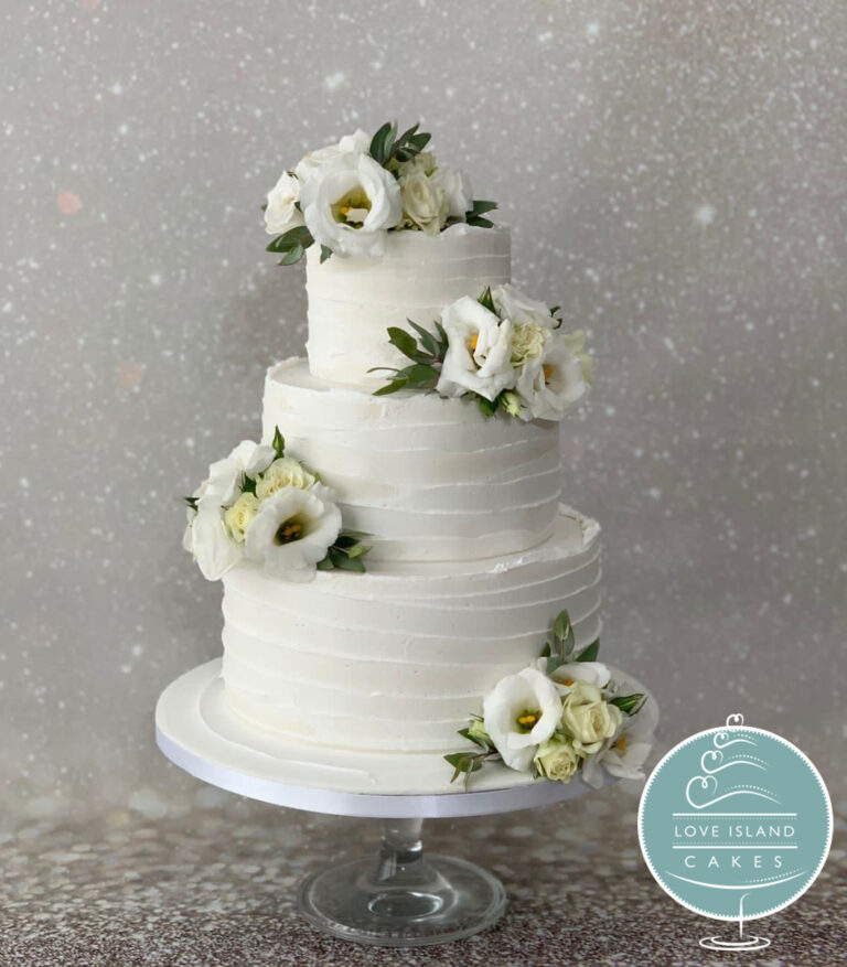 A three-tier ridged cake with ivory lisianthus and greenery, Love Island Cakes