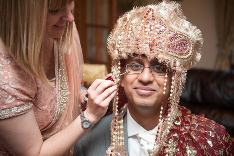 The groom's sehra being tied at his family home before the ceremony, Indian family wedding, Lovexposed Photography