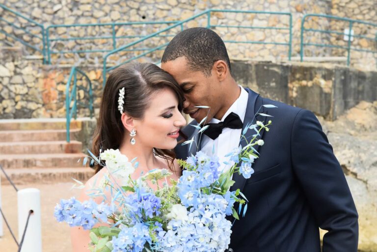 The couple with a blue hydrangea bouquet by the water on Capri; styled wedding shoot, Lovexposed Photography