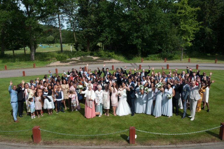 Every guest gathered on the lawn for the group photograph; Joelle and Tashan's wedding at Gilwell, Essex, Lovexposed Photography