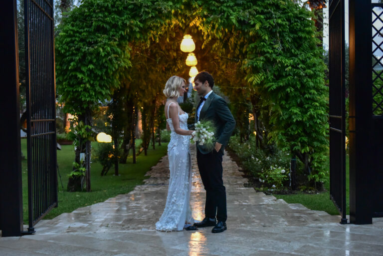 The couple under a lantern-lit green archway on the Paestum styled wedding shoot in the Cilento, hosted by the Savoy Hotel & Spa, Lovexposed Photography