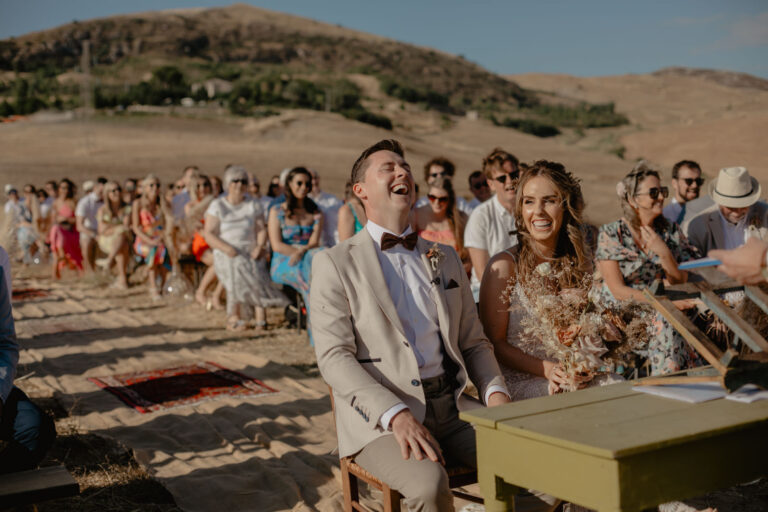 A hillside ceremony at Masseria Susafa, guests seated among the inland hills, LOVIÙ Events