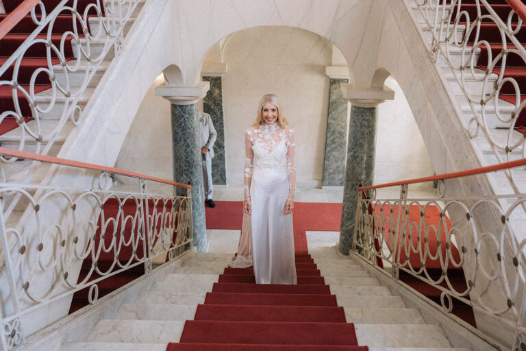 A red-carpeted double staircase inside a palazzo in Noto, LOVIÙ Events