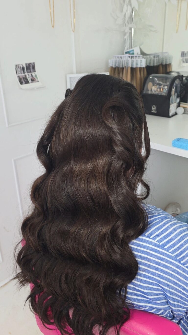 Dark curled hair, styled in front of a small mirror, Loxus Hair and Makeup