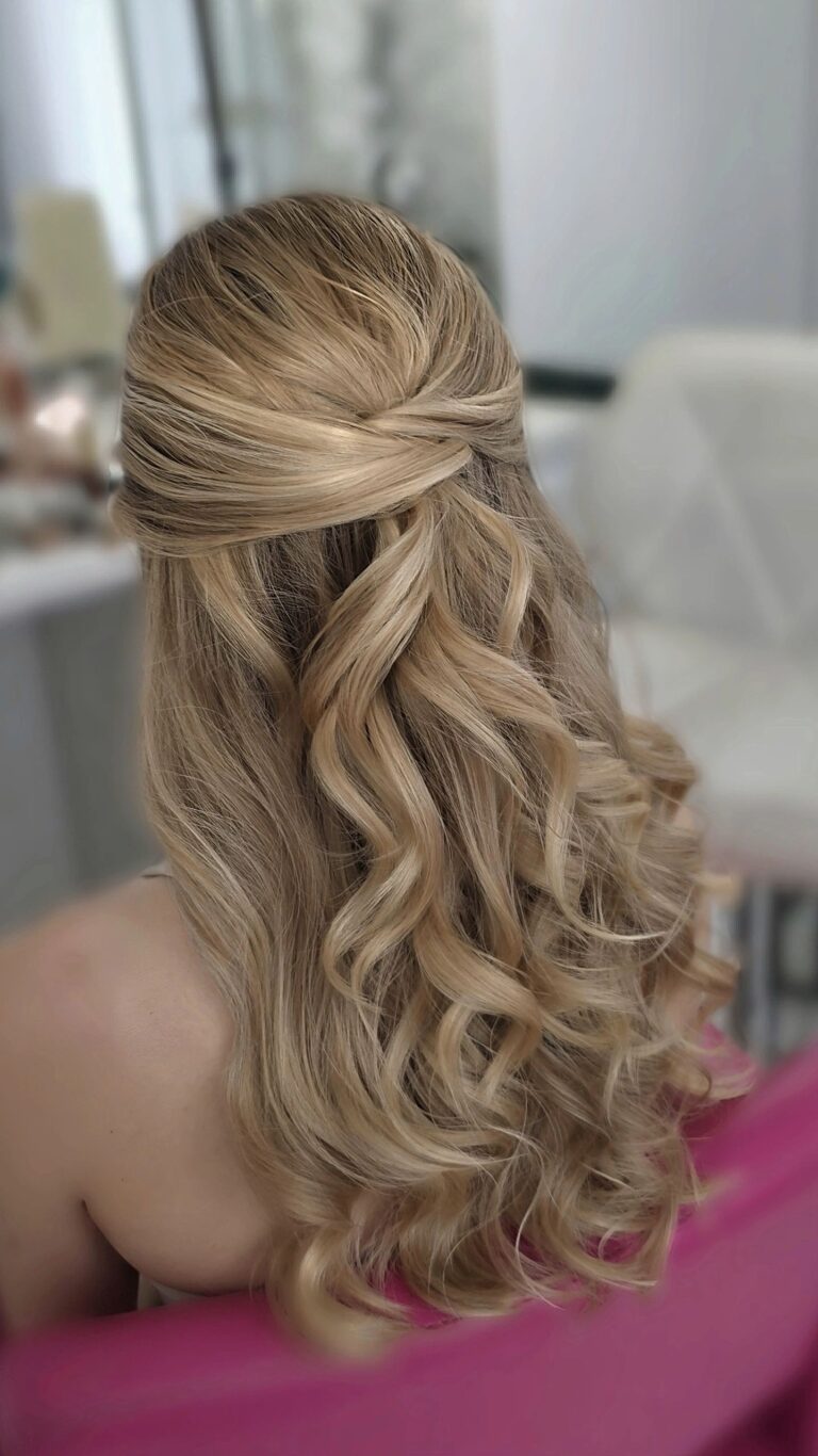 Blonde half-up curls, styled at a salon mirror, Loxus Hair and Makeup