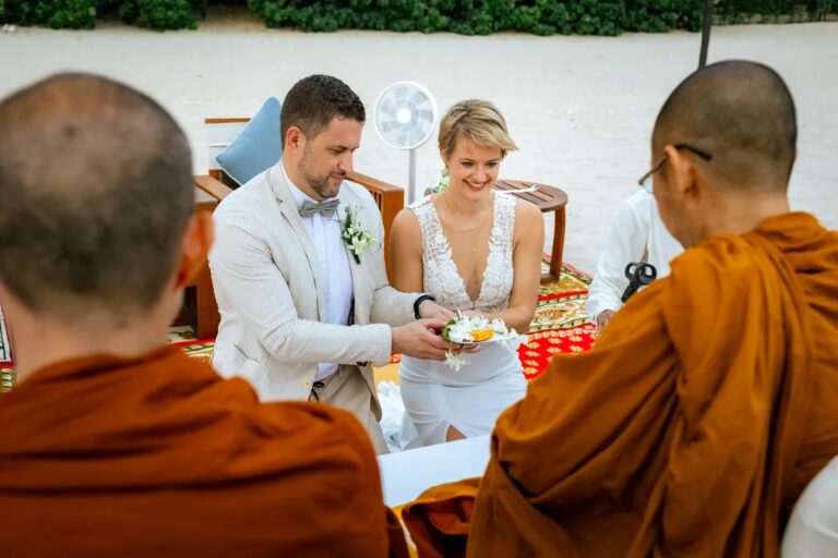 A couple seated between monks during a Thai Buddhist blessing on the beach, Koh Lanta, Lucida Image