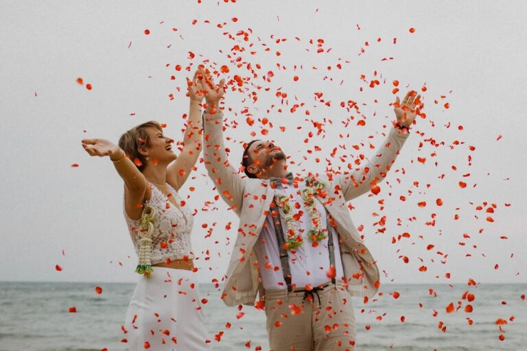 A couple tossed in red rose petals beside the sea, Koh Lanta, Lucida Image