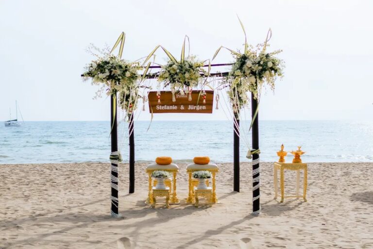 A beach ceremony set beneath a flower-topped wooden canopy beside the sea, Koh Lanta, Lucida Image