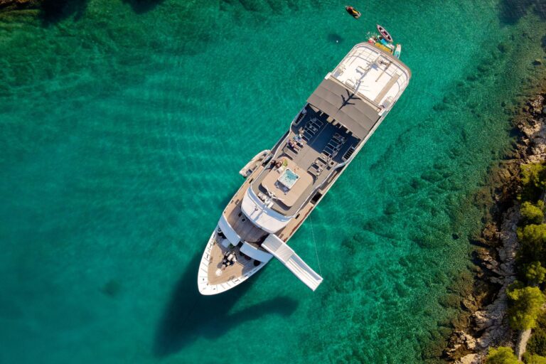Aerial view of the yacht in a turquoise cove, Lupus Mare