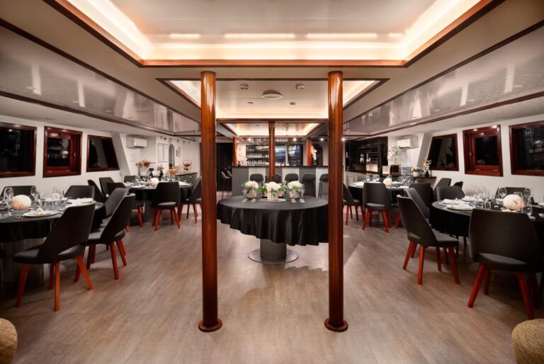 The saloon dining area with its columns and tables laid for dinner, Lupus Mare