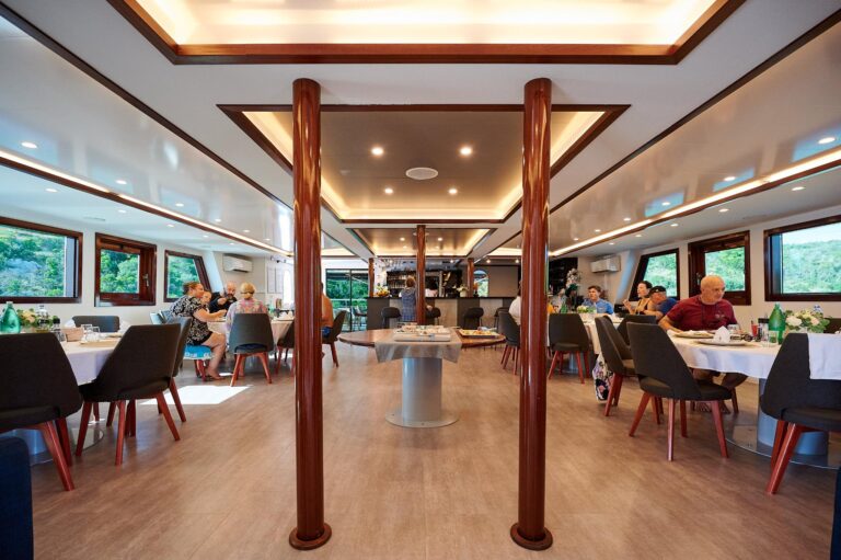 The saloon, with dining tables beside the windows, Lupus Mare