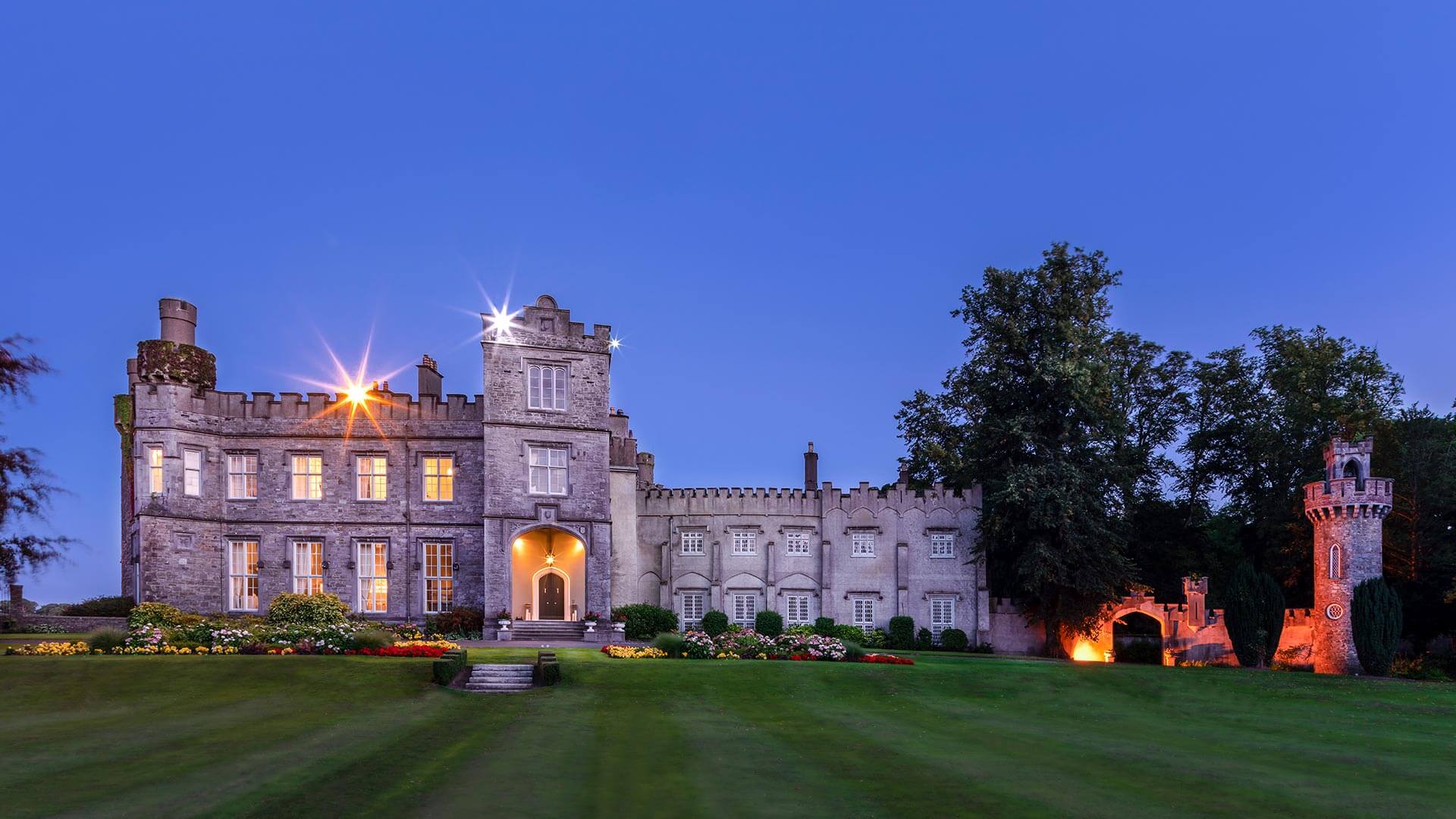 Luttrellstown Castle lit at dusk across the lawn, Luttrellstown Castle Resort