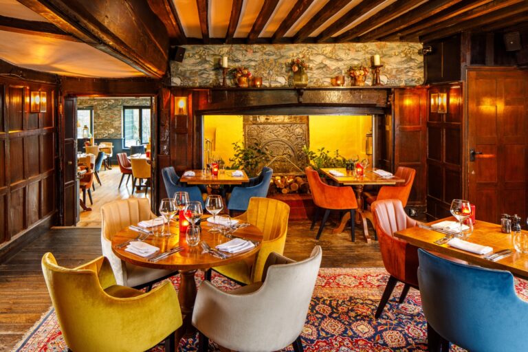 The panelled Tudor restaurant with exposed beams and warm lamplight, Lythe Hill Hotel & Spa