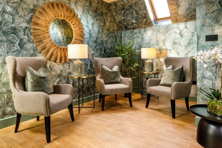 A relaxation lounge in the Armana Spa with soft armchairs and a gilt mirror, Lythe Hill Hotel & Spa