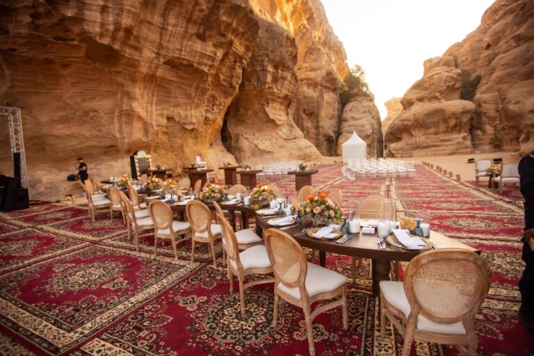 Banquet tables on red carpets with ceremony seating beyond, Mövenpick Resort Petra