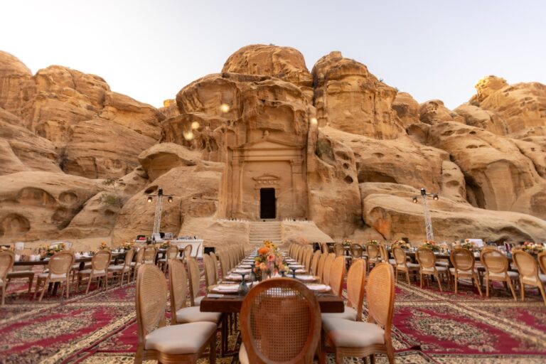 Dinner tables set before a carved Little Petra facade, Mövenpick Resort Petra
