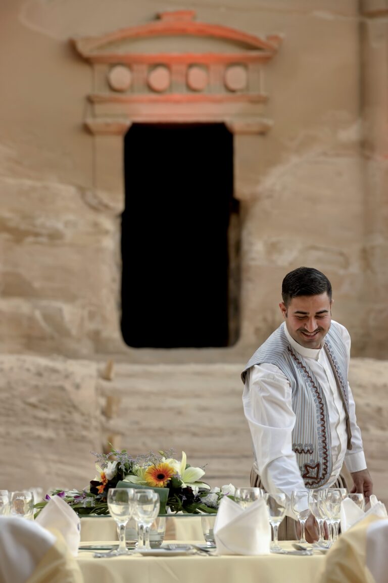 Banquet table laid before a carved doorway at Little Petra, Mövenpick Resort Petra