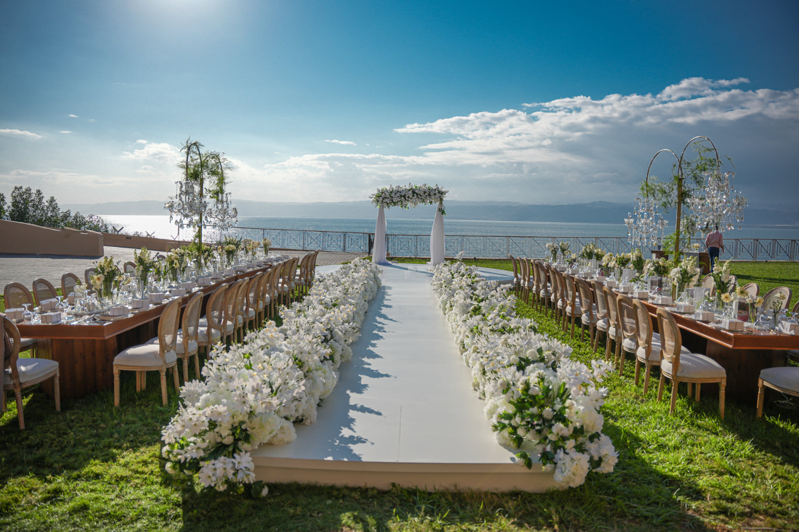 Ceremony aisle and floral arch on the lawn facing the sea, Mövenpick Resort & Spa Dead Sea