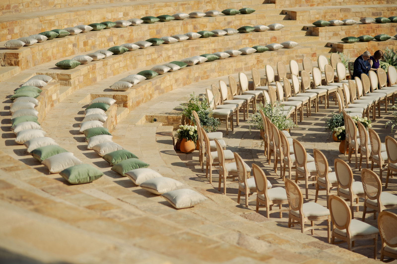 Ceremony chairs set in the stone tiers of an outdoor arena, Mövenpick Resort & Spa Dead Sea