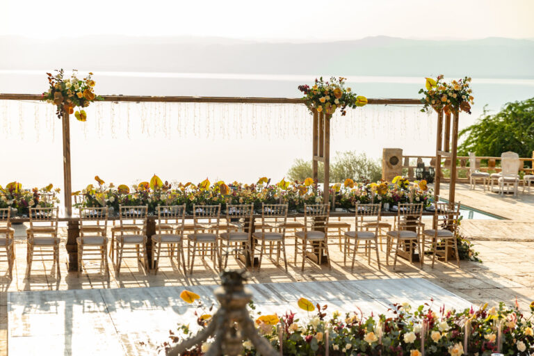 Terrace banquet set with floral garlands and the sea beyond, Mövenpick Resort & Spa Dead Sea