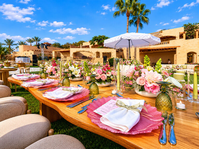 Pink floral tables on the lawn in front of the resort buildings, Mövenpick Resort & Spa Dead Sea