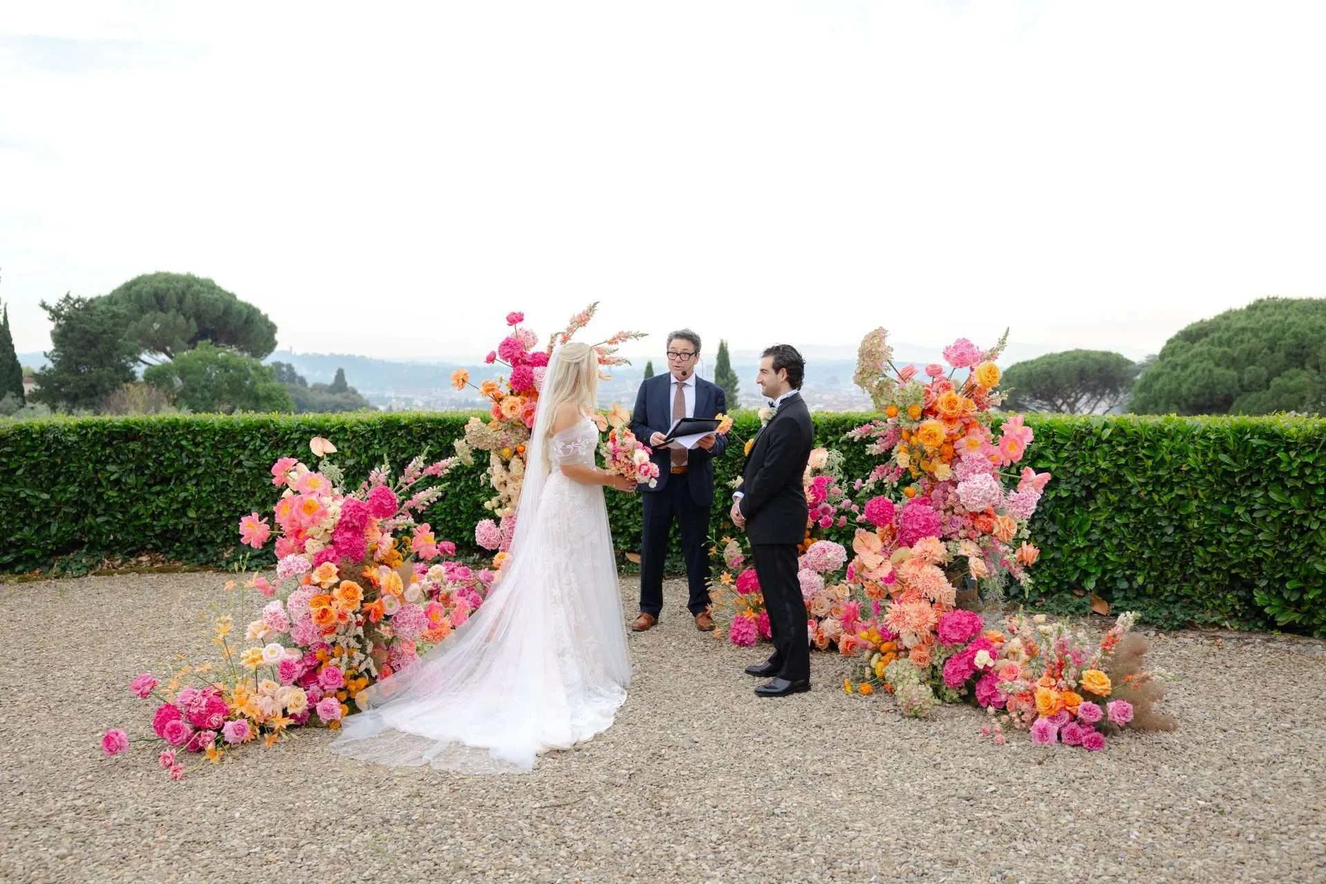 The ceremony seen from behind, hedges and the hills of Florence beyond, Magnolia Wedding Planner