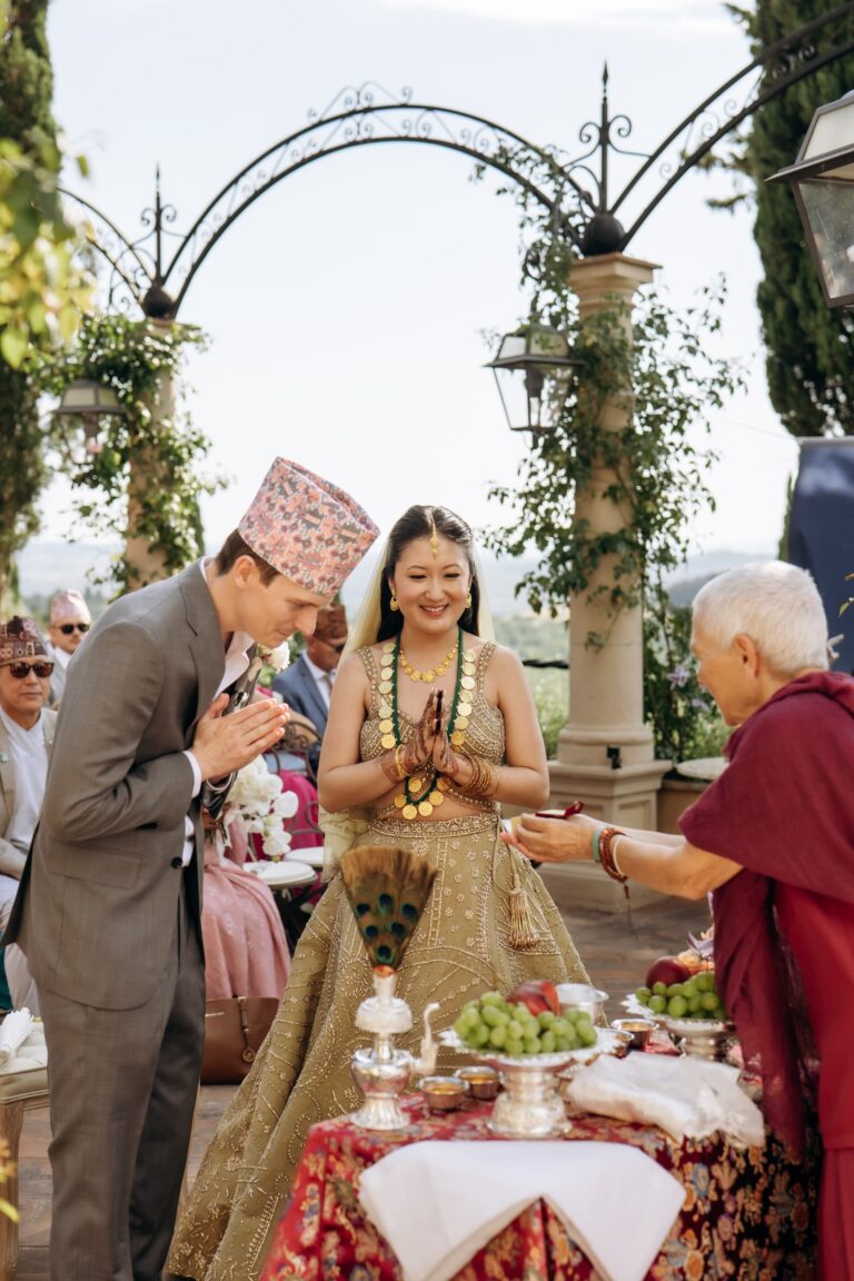 The Nepali rites at the table, the priest in red, the groom in a topi cap, Magnolia Wedding Planner