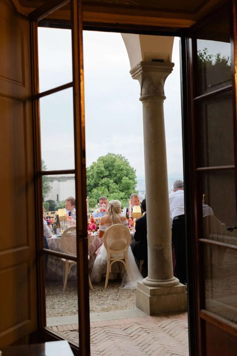 Through the open doors of the loggia to the dinner beyond, Magnolia Wedding Planner