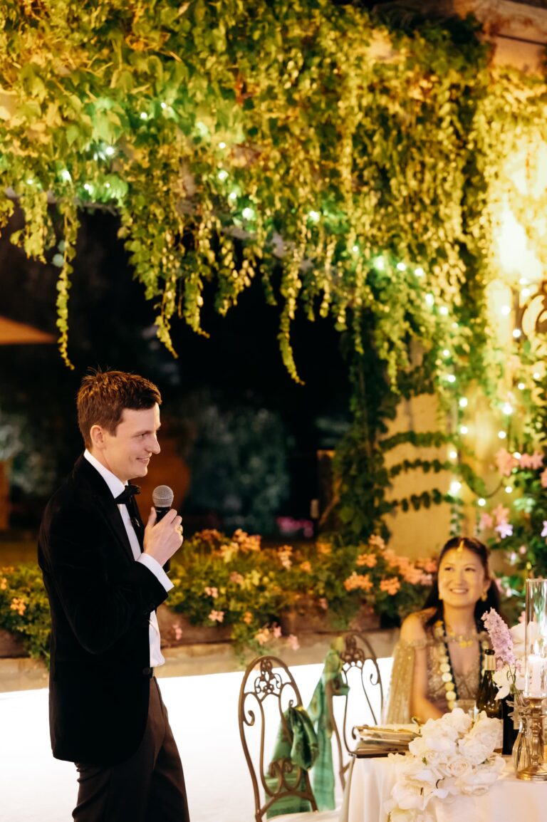 A speech under a hanging curtain of amaranthus and greenery, Magnolia Wedding Planner