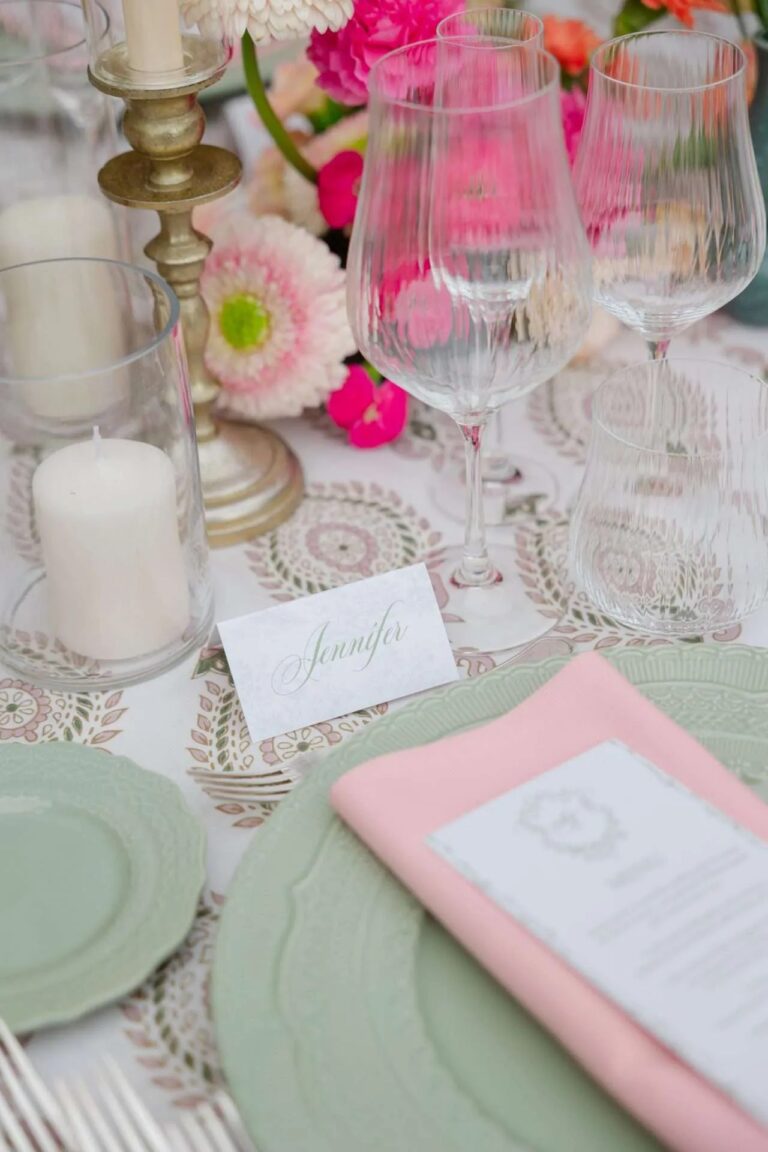 Sage plates, a pink menu card, coloured glass and a candle at each place, Magnolia Wedding Planner