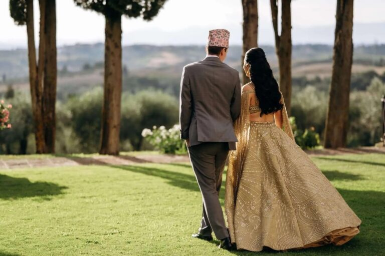 Crossing the lawn towards the olive trees, the Chianti hills behind, Magnolia Wedding Planner