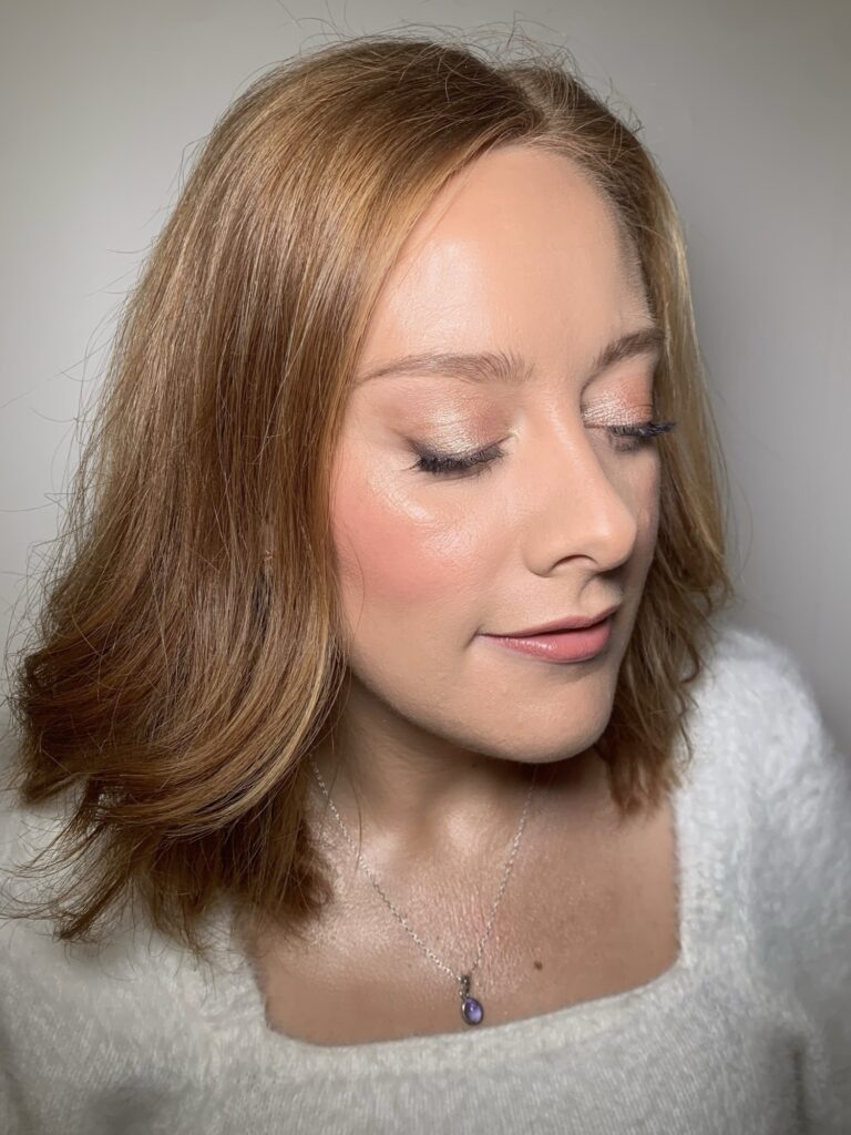 A woman in profile, soft blonde waves, dewy skin, Makeup By Becky Flynn