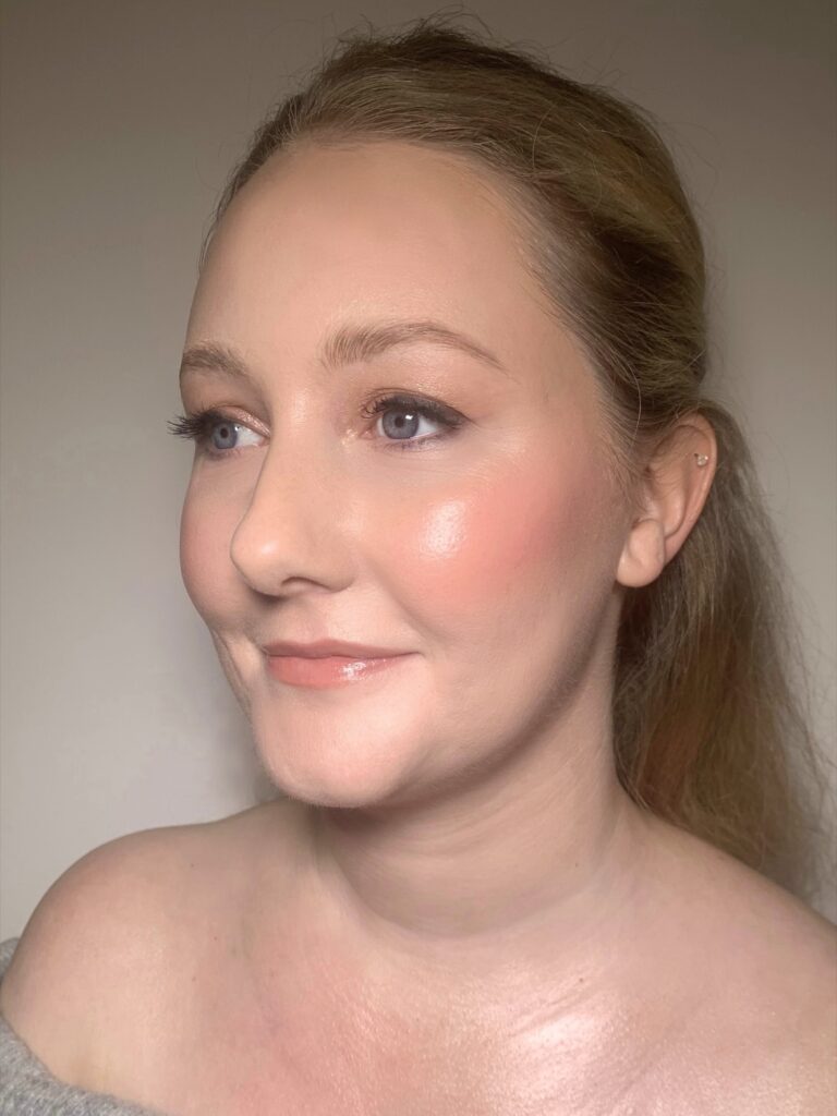 A woman in profile, blonde hair, glowing skin, Makeup By Becky Flynn