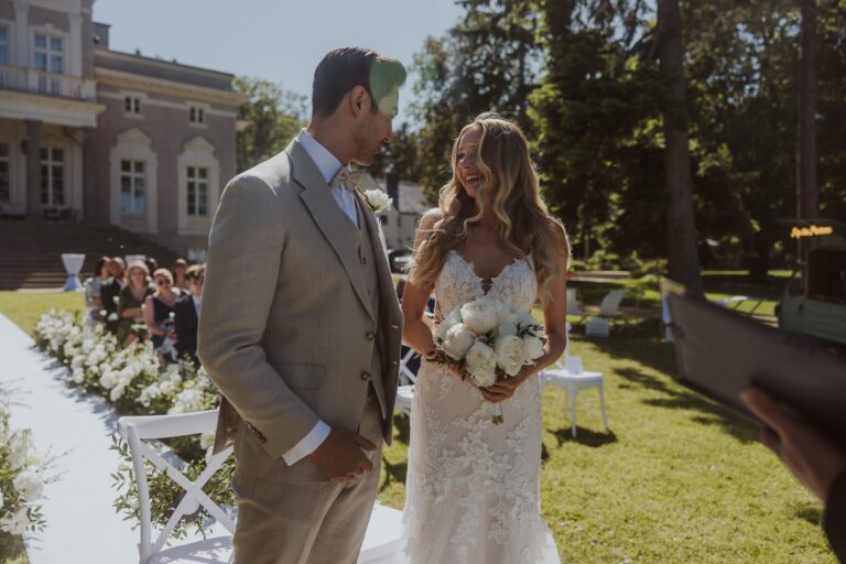 Couple at an outdoor ceremony on the garden lawn, Manowce Palace