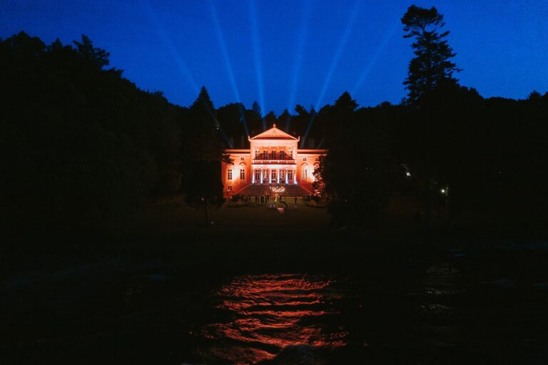 Palace illuminated at night above the lagoon, Manowce Palace
