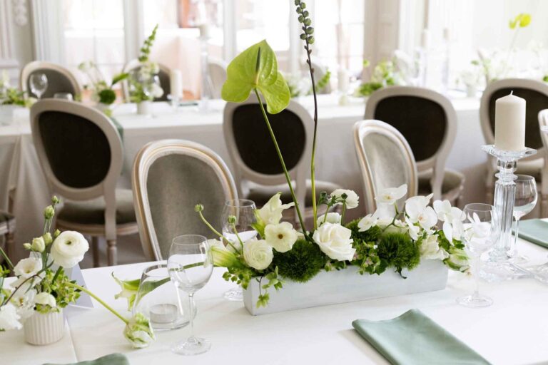 Table setting with white floral centrepieces, Manowce Palace