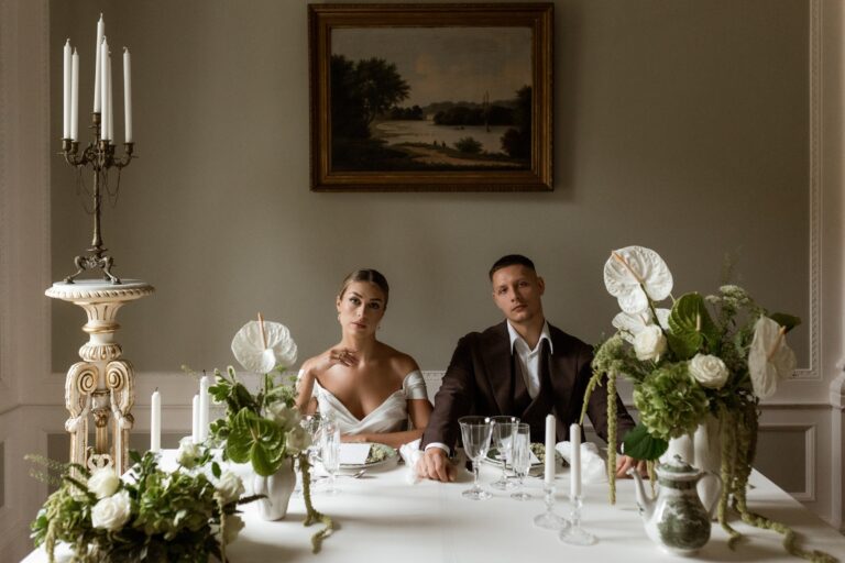 Couple at a candlelit table in a panelled dining room, Manowce Palace