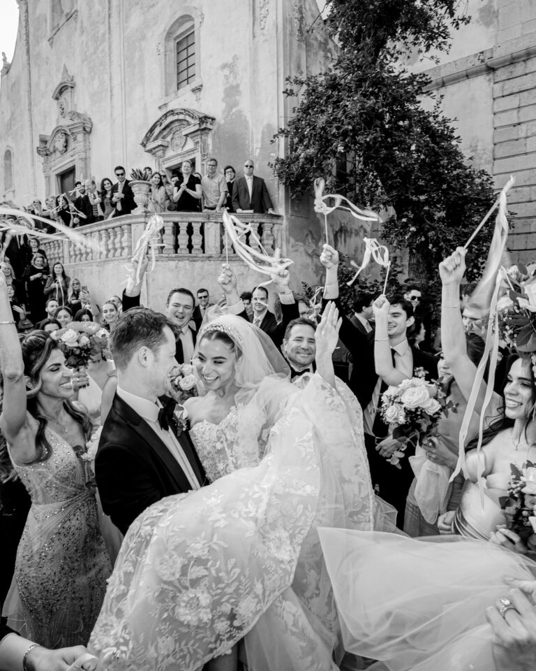 Guests cheering the couple with ribbons at the church steps, Marco Ficili