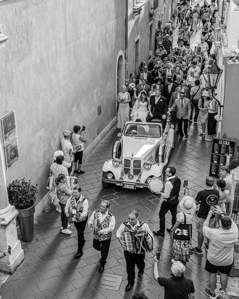 The wedding procession winding through a narrow Sicilian street, Marco Ficili