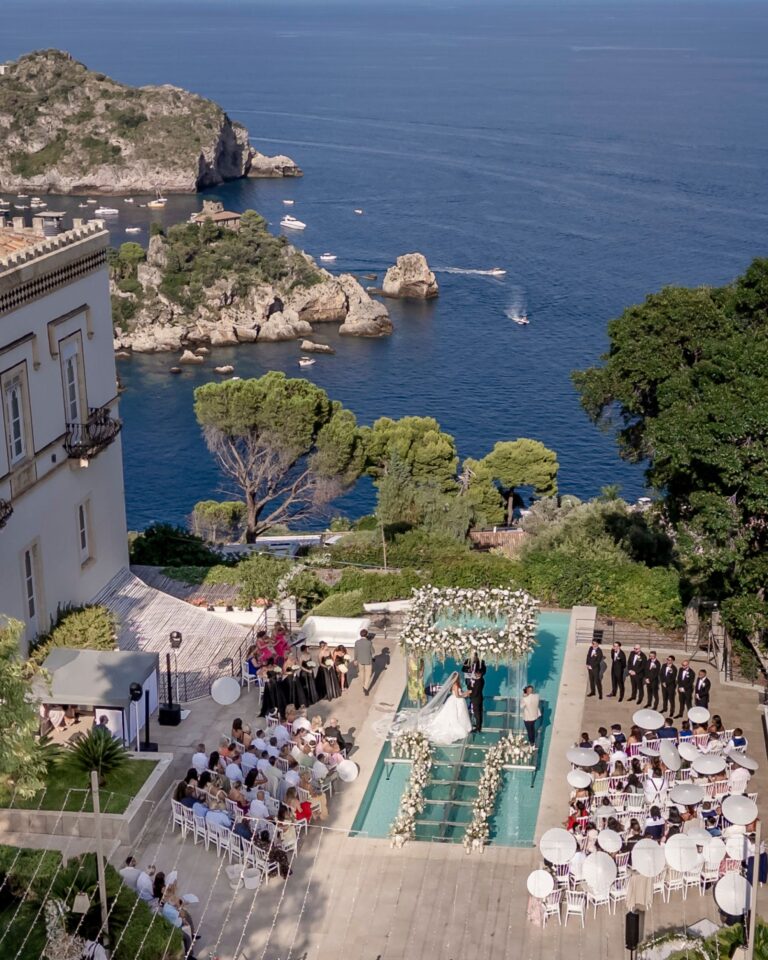 Aerial view of a seaside ceremony above the bay on the Sicilian coast, Marco Ficili